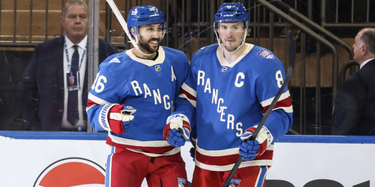 New York Rangers players Vincent Trocheck (16) and J.T. Miller (8) celebrate a goal.