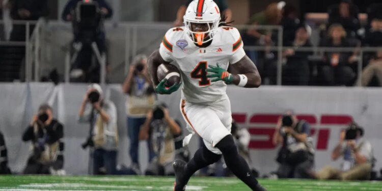 Miami Hurricanes defensive lineman Rueben Bain Jr. (4) moves the ball against the Ohio State Buckeyes.