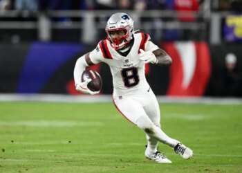 Stefon Diggs running with the football during an NFL game.