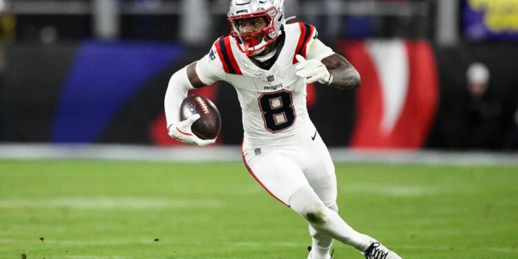 Stefon Diggs running with the football during an NFL game.