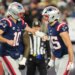 New England Patriots tight end Hunter Henry (85) celebrates with New England Patriots quarterback Drake Maye (10) after scoring a touchdown during the fourth quarter against the Los Angeles Chargers in an AFC Wild Card Round game at Gillette Stadium.