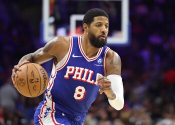 Georges Niang in a Philadelphia 76ers uniform dribbling a basketball.