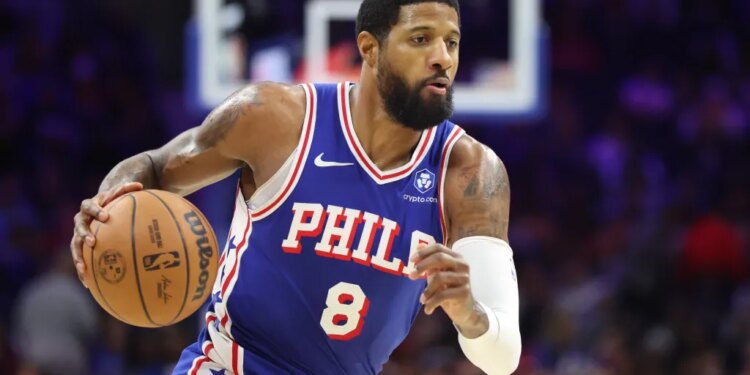 Georges Niang in a Philadelphia 76ers uniform dribbling a basketball.