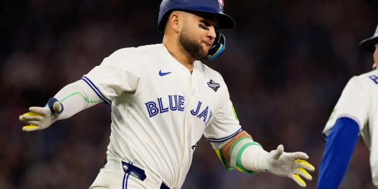 Bo Bichette in a Toronto Blue Jays uniform celebrates a three-run home run.