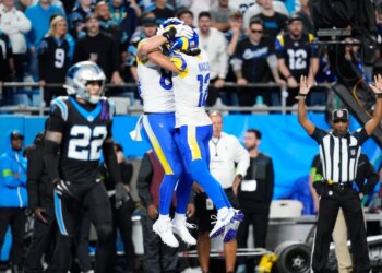 Los Angeles Rams tight end Colby Parkinson, center left, celebrates his touchdown catch with wide receiver Puka Nacua (12) during the second half of an NFL wild-card playoff football game against the Carolina Panthers, Saturday, Jan. 10, 2026, in Charlotte, N.C.