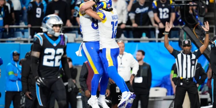 Los Angeles Rams tight end Colby Parkinson, center left, celebrates his touchdown catch with wide receiver Puka Nacua (12) during the second half of an NFL wild-card playoff football game against the Carolina Panthers, Saturday, Jan. 10, 2026, in Charlotte, N.C.
