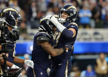 Los Angeles Chargers running back Omarion Hampton (8) celebrates his touchdown with quarterback Justin Herbert (10).