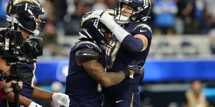 Los Angeles Chargers running back Omarion Hampton (8) celebrates his touchdown with quarterback Justin Herbert (10).