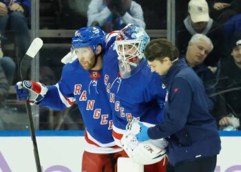 New York Rangers goaltender Igor Shesterkin is helped off the ice by a trainer and New York Rangers defenseman Vladislav Gavrikov after falling back on his leg in the first period at Madison Square Garden in Manhattan, New York, Monday, January 05, 2026.