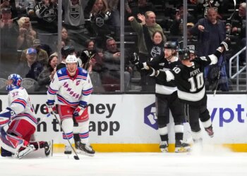 Los Angeles Kings right wing Adrian Kempe, second from right, celebrates his goal with right wing Corey Perry, right, as New York Rangers goaltender Jonathan Quick, left, and center J.T. Miller stand by during the first period of an NHL hockey game Tuesday, Jan. 20, 2026, in Los Angeles.