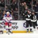 Los Angeles Kings right wing Adrian Kempe, second from right, celebrates his goal with right wing Corey Perry, right, as New York Rangers goaltender Jonathan Quick, left, and center J.T. Miller stand by during the first period of an NHL hockey game Tuesday, Jan. 20, 2026, in Los Angeles.