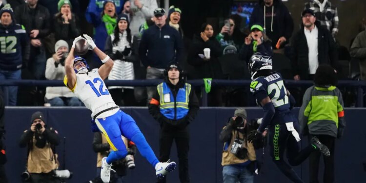 Rams wide receiver Puka Nacua (12) makes a touchdown catch past Seahawks cornerback Riq Woolen (27) during the second half of the NFC Championship game on Jan. 25, 2026.