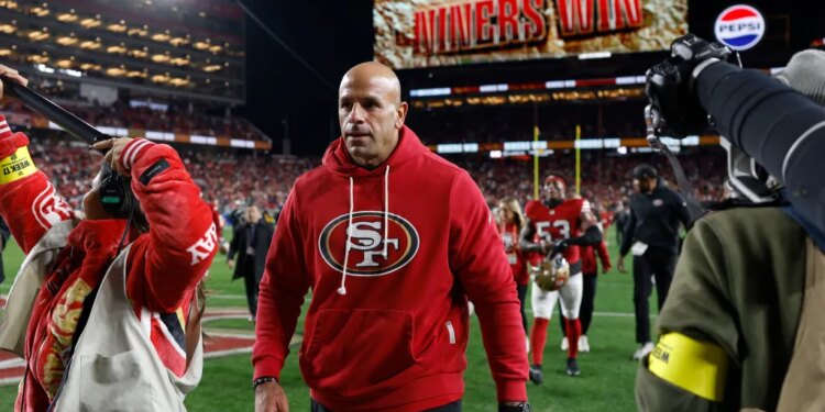 San Francisco 49ers defensive coordinator Robert Saleh leaves the field after defeating the Chicago Bears.