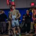 Anthony Knox Jr., a three-time state wrestling champion, stands in his wrestling singlet, facing a competitor.