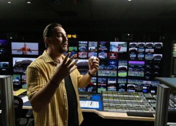 Director John Marisco holding a baseball in the SportsNet New York (SNY) production truck.