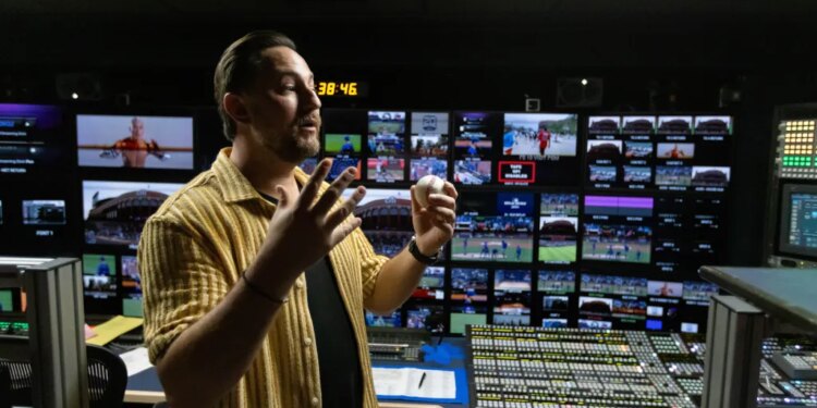 Director John Marisco holding a baseball in the SportsNet New York (SNY) production truck.