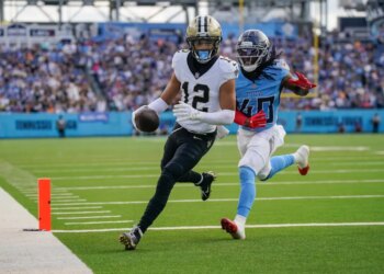 New Orleans Saints wide receiver Chris Olave (12) runs a touchdown in front of Tennessee Titans cornerback Kemon Hall (40)