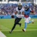 New Orleans Saints wide receiver Chris Olave (12) runs a touchdown in front of Tennessee Titans cornerback Kemon Hall (40)