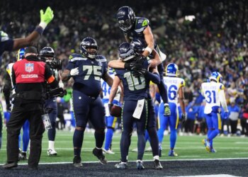 Seattle Seahawks wide receiver Cooper Kupp (10) celebrates his touchdown catch with teammates during the second half of the NFC Championship NFL football game against the Los Angeles Rams Sunday, Jan. 25, 2026, in Seattle.