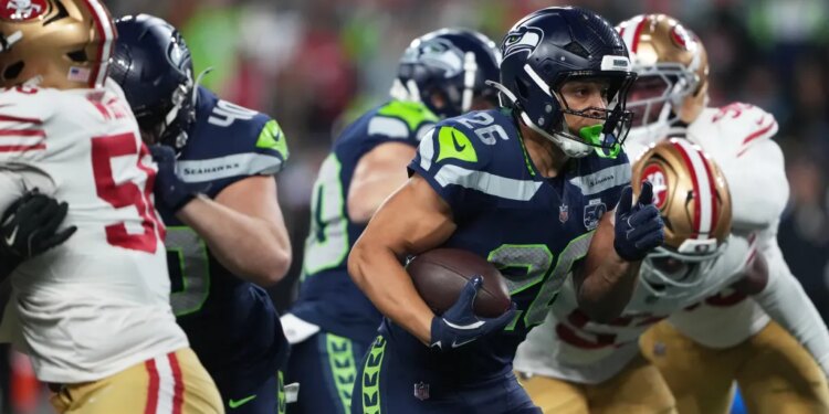 Seattle Seahawks running back Zach Charbonnet (26) holds on to the ball during the team's win over the 49ers on Jan. 17, 2026.