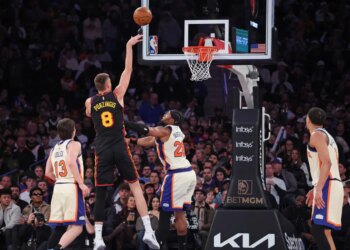 Atlanta Hawks center Kristaps Porzingis #8 shoots over New York Knicks forward Guerschon Yabusele #28.