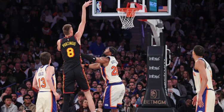 Atlanta Hawks center Kristaps Porzingis #8 shoots over New York Knicks forward Guerschon Yabusele #28.