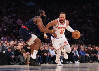 New York Knicks guard Jalen Brunson #11, dribbling the ball and guarded by LA Clippers guard James Harden #1.