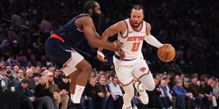 New York Knicks guard Jalen Brunson #11, dribbling the ball and guarded by LA Clippers guard James Harden #1.