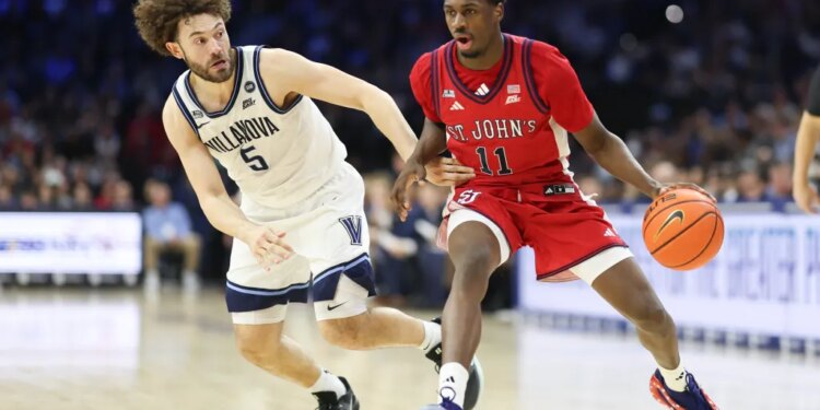 St. John's Red Storm guard Ian Jackson (11) drives against Villanova Wildcats guard Devin Askew (5) during the second half at Xfinity Mobile Arena.