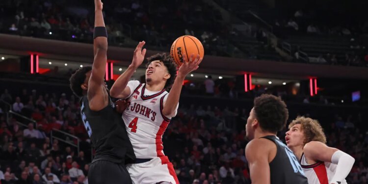 St. John's Red Storm guard Oziyah Sellers #4 goes up for a shot as Marquette Golden Eagles guard Tre Norman #5 defends.