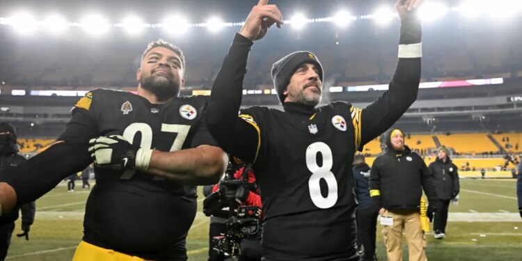 Aaron Rodgers (8) and Cam Heyward celebrate the Steelers' playoff-clinching win over the Ravens on Jan. 4, 2026.