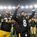 Aaron Rodgers (8) and Cam Heyward celebrate the Steelers' playoff-clinching win over the Ravens on Jan. 4, 2026.