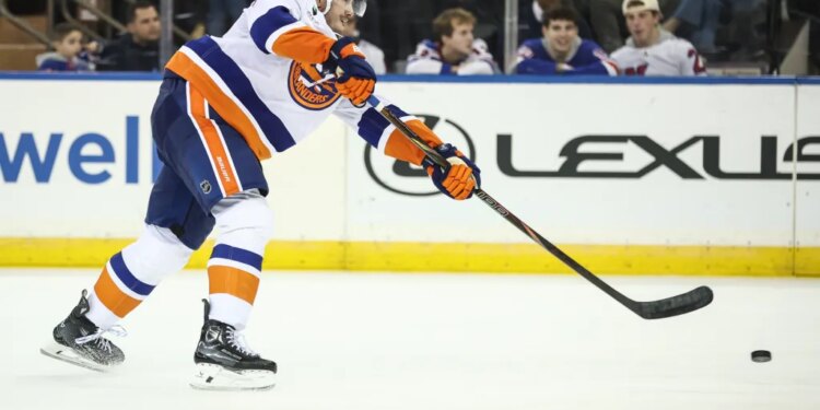 New York Islanders defenseman Alexander Romanov (28) attempts a shot on goal in the second period against the New York Rangers at Madison Square Garden.