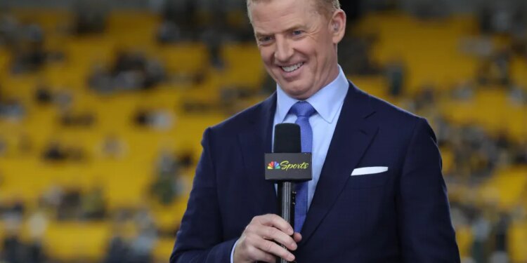 Sportscaster smiling, holding a microphone with an NBC Sports logo.