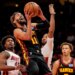 Atlanta Hawks guard Trae Young (11) shoots past Miami Heat guard Davion Mitchell (45) during the first half of an NBA basketball game, Friday, Dec. 26, 2025, in Atlanta.