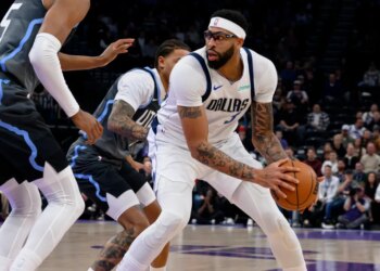 Dallas Mavericks forward Anthony Davis, right, posts up against Utah Jazz guard Keyonte George, center, during the first half of an NBA basketball game, Thursday, Jan. 8, 2026, in Salt Lake City.