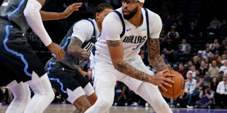 Dallas Mavericks forward Anthony Davis, right, posts up against Utah Jazz guard Keyonte George, center, during the first half of an NBA basketball game, Thursday, Jan. 8, 2026, in Salt Lake City.