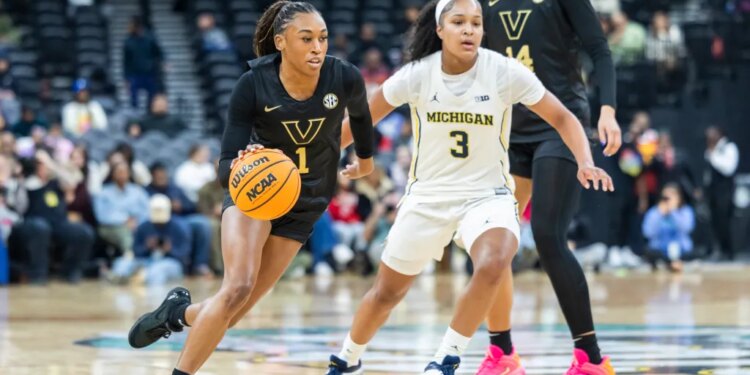 Vanderbilt Commodores guard Mikayla Blakes (1) drives around Michigan Wolverines guard Mila Holloway (3) during the first half of the Coretta Scott King Classic at the Prudential Center, Monday, Jan. 19, 2026, in Newark, NJ.
