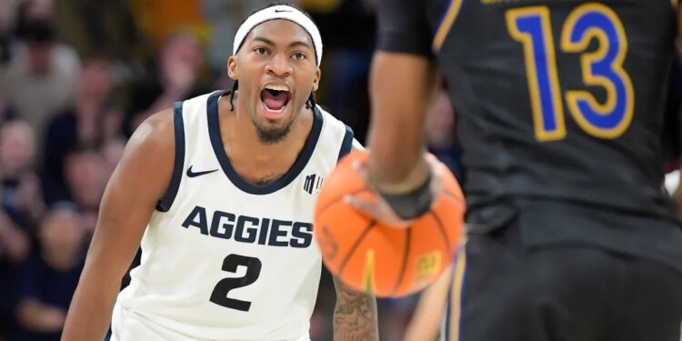 Utah State guard MJ Collins Jr. (2) yells after making a 3-pointer as San Jose State guard Jermaine Washington (13) brings the ball down the court.