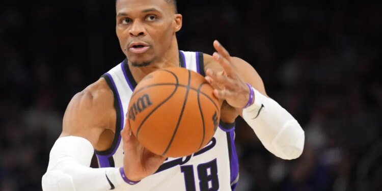 Sacramento Kings player with the ball during a game against the Phoenix Suns.