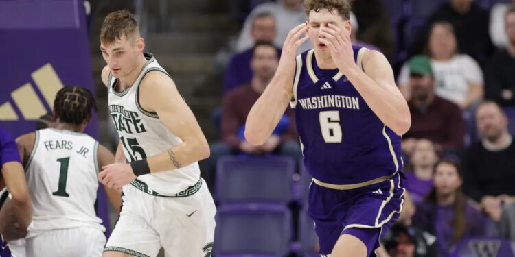 Washington forward Hannes Steinbach (6) reacts after missing a shot as Michigan State center Carson Cooper (15) heads up court.