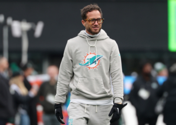 Miami Dolphins head coach Mike McDaniel in a grey hoodie with the team logo.