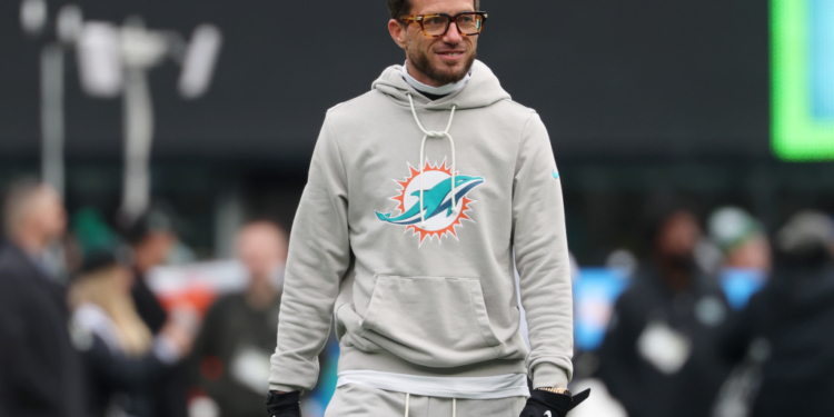 Miami Dolphins head coach Mike McDaniel in a grey hoodie with the team logo.