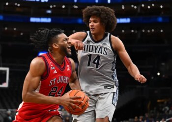 St. John's forward Zuby Ejiofor drives to the basket as Georgetown center Seal Diouf defends during the first half Wednesday night in Washington.