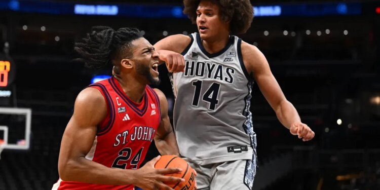 St. John's forward Zuby Ejiofor drives to the basket as Georgetown center Seal Diouf defends during the first half Wednesday night in Washington.