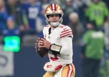 San Francisco 49ers quarterback Brock Purdy looks to throw during an NFL football playoff game.