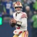 San Francisco 49ers quarterback Brock Purdy looks to throw during an NFL football playoff game.