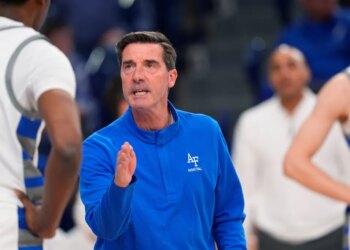 Air Force head coach Joe Scott talks to player Byron Brown during an NCAA college basketball game.