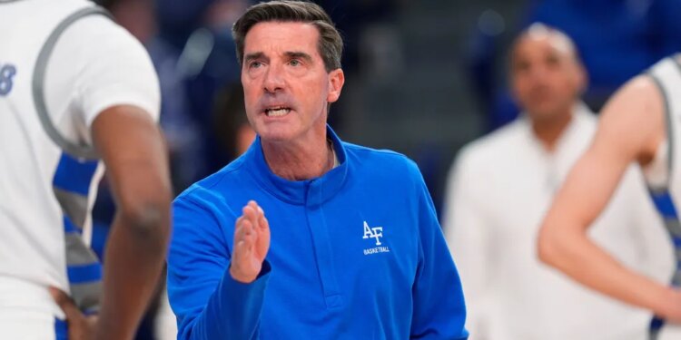 Air Force head coach Joe Scott talks to player Byron Brown during an NCAA college basketball game.
