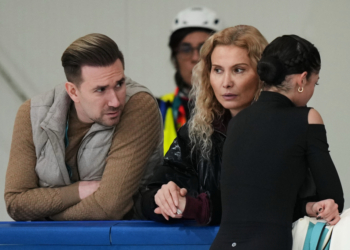 Adeliia Petrosian (right) speaks with coach Eteri Tutberidze (centeR) and choreographer Daniil Gleikhengauz, during a figure skating practice session at the 2026 Winter Olympics, in Milan, Italy, Monday, Feb. 16, 2026.